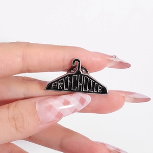Pro-Choice slogan clothes hanger enamel lapel pin in black with silver trim detail