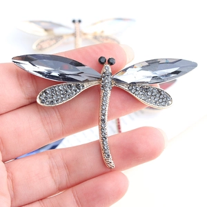 Macro shot of dragonfly brooch with grey pear-cut crystals and pavé rhinestones