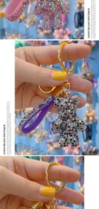 Close-up of a luxury rhinestone bear keychain with a sparkling crystal leather strap