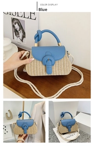 Close-up of blue leather flap and woven straw texture on minimalist square handbag