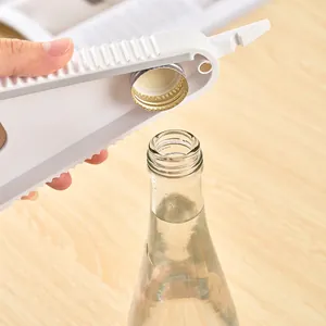 Japanese style white multifunctional jar opener for various bottle caps on wooden table