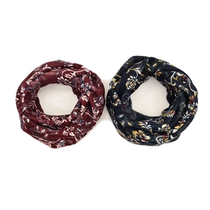 Close-up of dual-layer floral knit infinity scarves in burgundy and navy blue colors