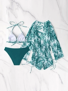 Flat lay of 3-piece swimsuit set with white bikini and tropical leaf mesh cover-up