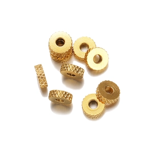 Macro view of 6mm gold stainless steel spacer beads with textured knurled pattern for jewelry