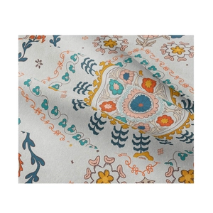 Close-up of ethnic floral tapestry fabric with cotton linen texture in vibrant colors