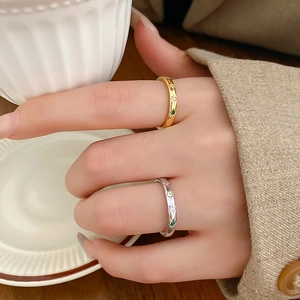Macro detail of gold and silver star engraved rings with colorful zircon on model hand
