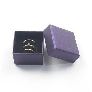 Detail shot of three elegant minimalist rings inside a premium purple jewelry gift box