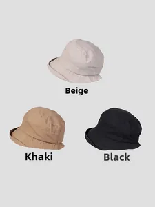 Close-up of lightweight cotton sun hats in beige, khaki, and black colors