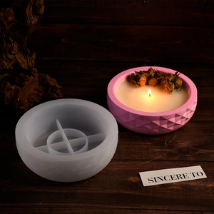 Detail of diamond pattern silicone mold and pink geometric candle holder on wood