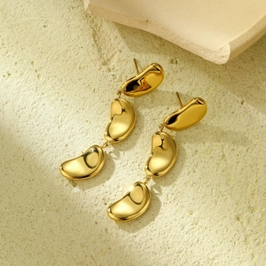 Vintage 18K gold-plated stainless steel triple bean drop earrings on stone background