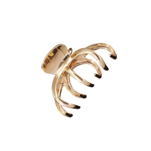 Large golden metal claw hair clip with multi-tooth design and shiny polished finish