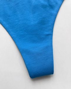 Macro shot of cobalt blue cotton thong fabric texture and stitching details