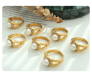 Detail of vintage 18K gold plated ring with freshwater pearl and zircon stones