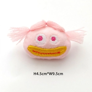 Detail of pink plush doll charm with embroidery measuring 4.5cm by 9.5cm size