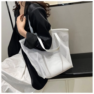 Modern white mesh tote bag on model showing large capacity and breathable PVC material
