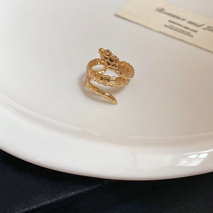 Macro shot of gold snake ring featuring intricate scale textures and wrap-around design