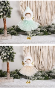 Detail of Christmas angel dolls with gold wings, mesh skirts, and bells on a pine branch