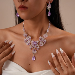 Vintage luxury silver jewelry set with purple floral crystals and teardrop pendants