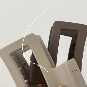 Macro view of matte Morandi beige and coffee rectangular hair claws with hollow design