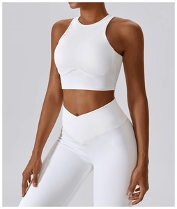 Detail of white ribbed sports set featuring high-waisted crossover leggings and racerback top