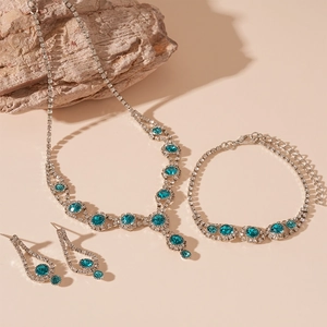 Detail view of vintage blue crystal jewelry set with necklace, bracelet and earrings