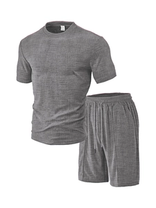 Close-up of waffle textured knit fabric on dark gray men's short sleeve polo and shorts set