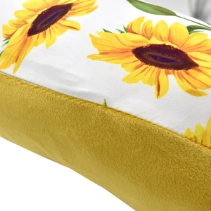 Detail of baby nursing pillow cover with sunflower pattern and yellow plush fabric texture