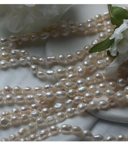 Macro shot of 6.5-7mm cream white baroque freshwater pearls with high luster shine