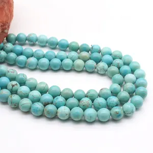 Macro shot of turquoise beads with brown matrix textures and raw stone accents