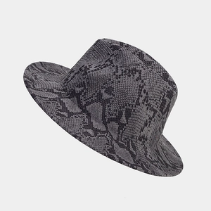 Detail of wide brim fedora hat featuring dark grey snake skin texture and wool-like finish
