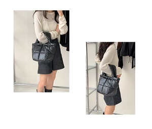 Close-up of lightweight black quilted puffer tote bag with wide padded handles for women