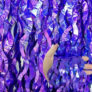 Detail shot of shimmering purple foil fringe curtain with metallic glitter texture