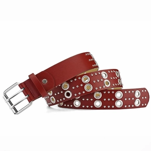 Close-up of red leather punk belt with double-row silver eyelets and metal buckle
