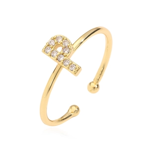 Detail of gold letter P ring with cubic zirconia inlay on a clean white background