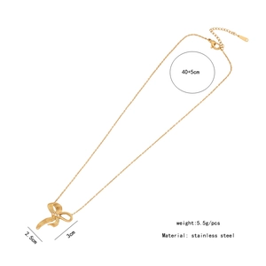 Detail of golden bow necklace showing 40+5cm length and 2.5x3cm pendant dimensions