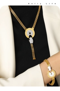 Detailed close-up of 18k gold snake head jewelry set with micro-pave crystals on a model