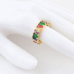 Detail of adjustable rainbow baguette zircon ring with gold base and colorful stones