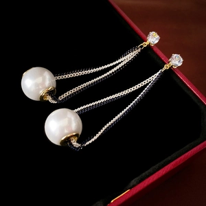 Elegant zircon pearl tassel earrings with silver needles on a black jewelry display box