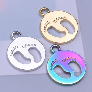 Detail of round footprint charms in gold, silver, and iridescent 18k plated stainless steel