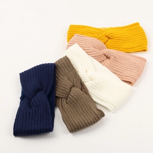 Detail shot of five knitted twisted headbands in yellow, pink, white, brown and navy blue