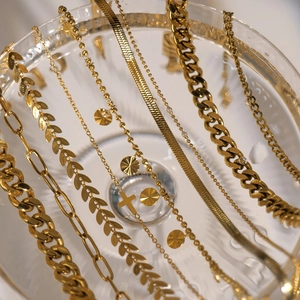 Detailed collection of 18K gold plated cross pendants, snake and Cuban link chains