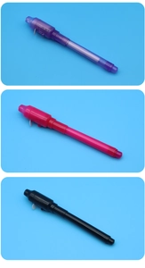 Macro shot of colorful invisible ink pens in purple pink and black with LED UV lights
