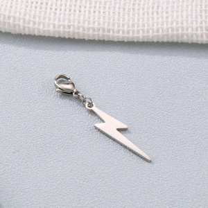 Silver lightning bolt charm with lobster clasp for DIY jewelry making on textured background
