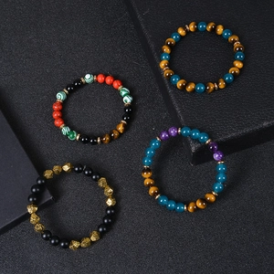 Close-up of handmade tiger eye and crystal beaded bracelets in multiple colors