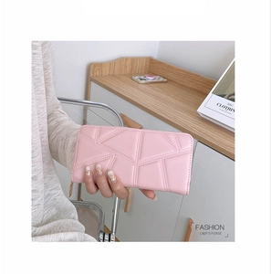 Pink long PU leather wallet with geometric quilted pattern held in hand for modern lifestyle
