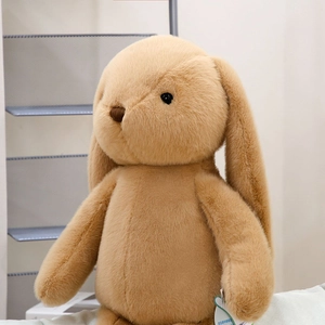 Close-up of soft khaki plush rabbit toy with fluffy long ears and embroidered nose