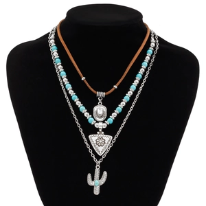 Detail view of layered bohemian necklace with turquoise beads and cactus pendant
