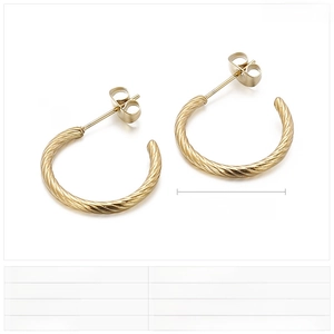 Detail view of 20mm gold twisted C-shaped earrings made of polished stainless steel