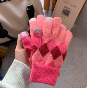 Detail of pink diamond pattern knit gloves with touchscreen-friendly grey fingertips