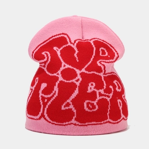 Close-up of pink beanie featuring red jacquard knit heart and urban letter patterns